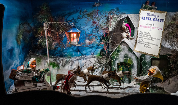 Santa’s Cave diorama showing Santa’s sleigh with reindeer, snowy house, and festive figures delivering toys.