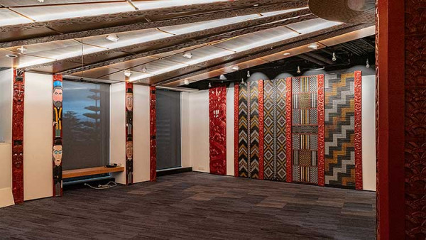 An example of culturally appropriate design, showcasing red traditional Māori designs on both the ceilings and walls.